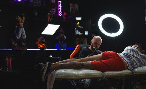 image of artist creating a tattoo