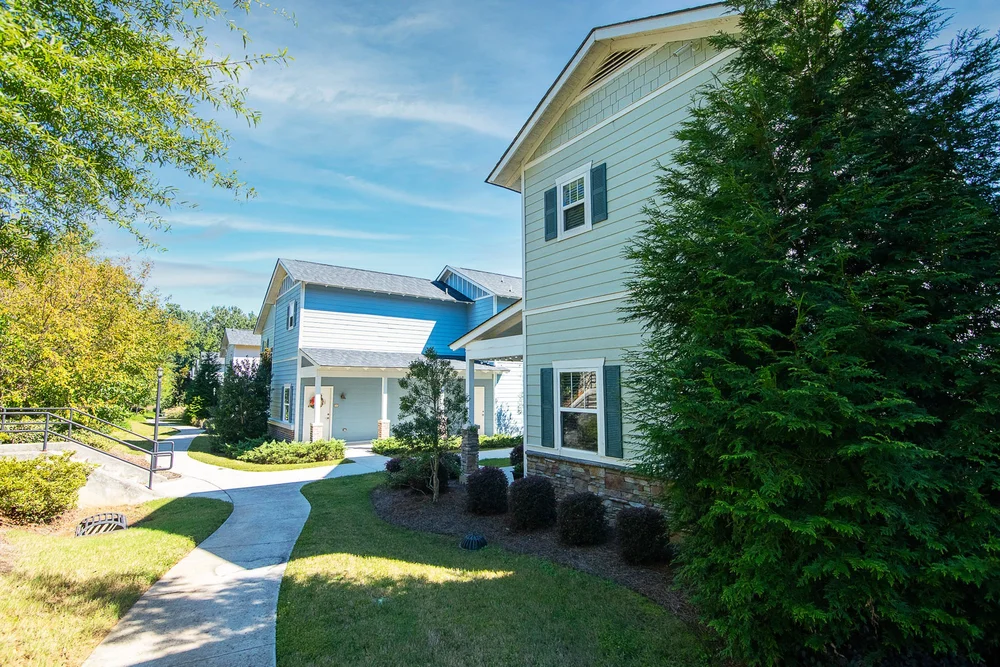 exterior walking path with greenery and shrubs