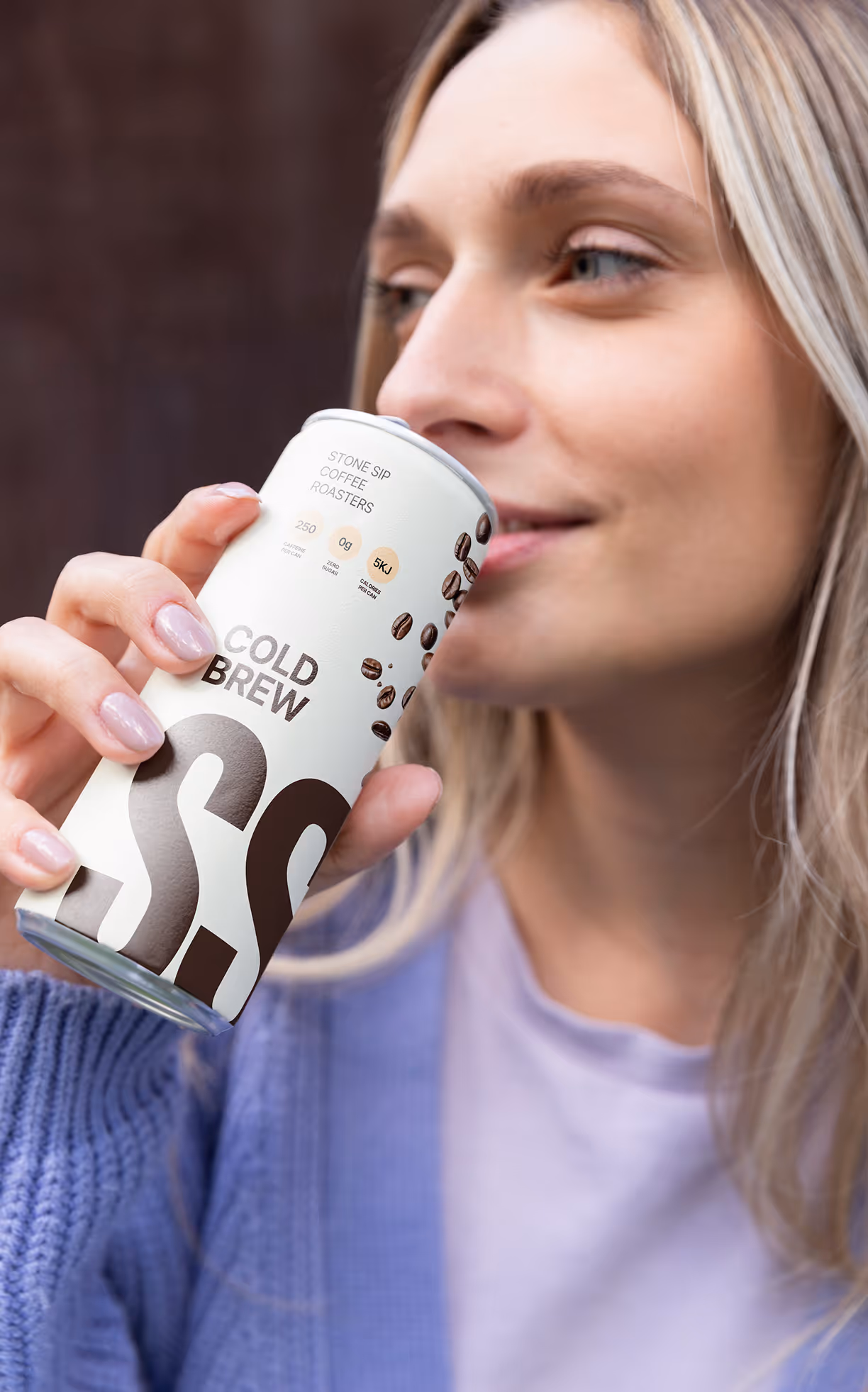 woman drinking stone sip cold brew in a casual lifestyle setting