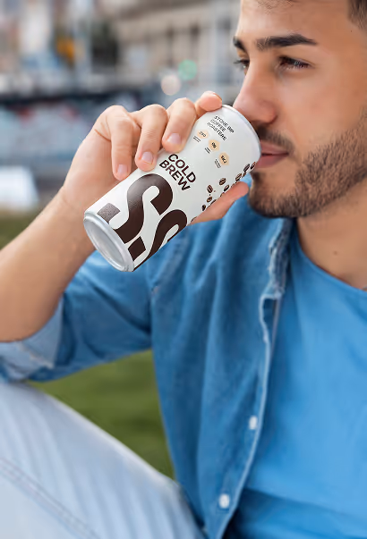man drinking stone sip cold brew coffee outdoors in relaxed lifestyle moment