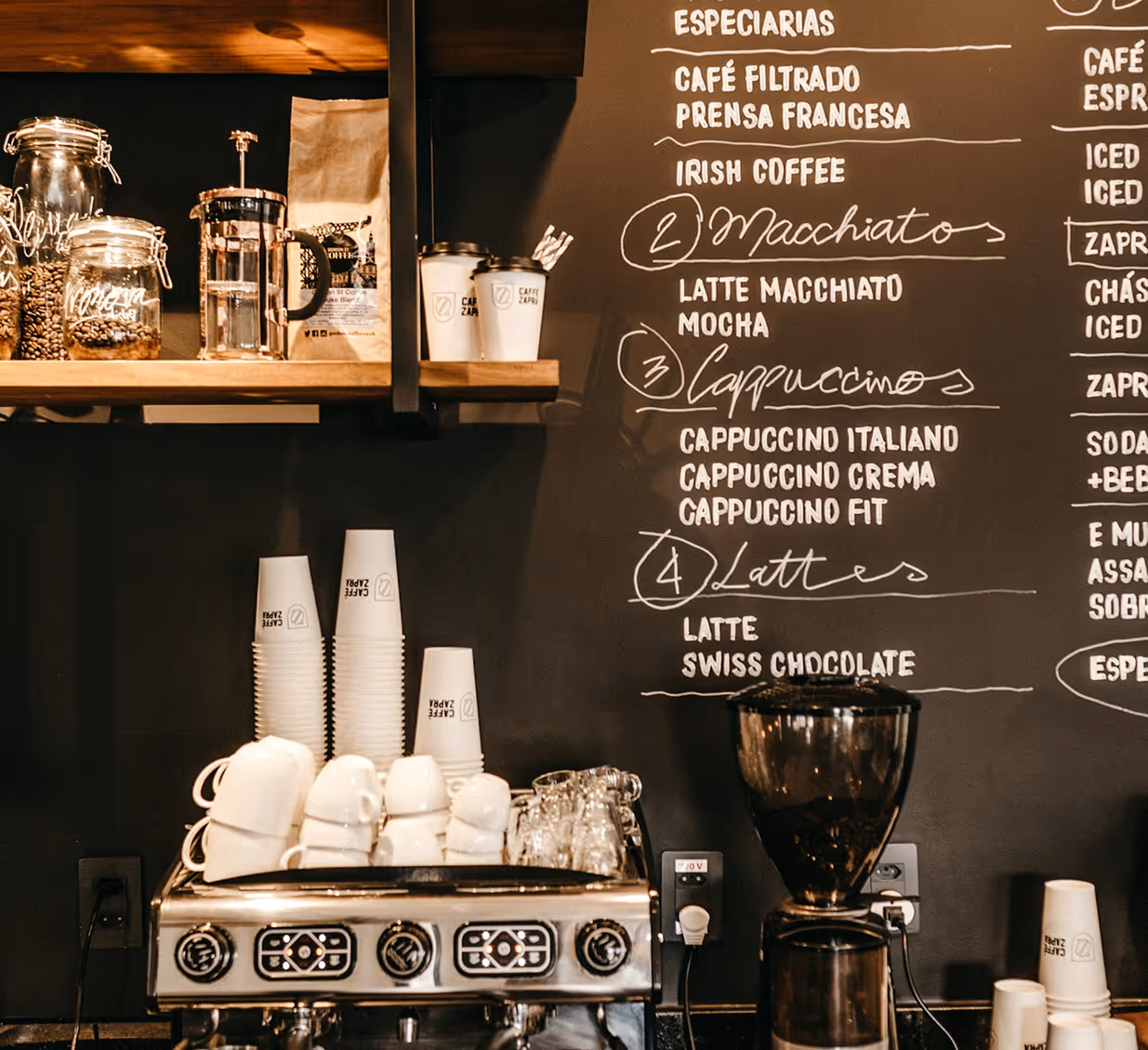 Professional espresso machine and coffee tools inside a specialty café.