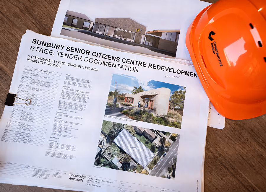 hard hat on top of building plans