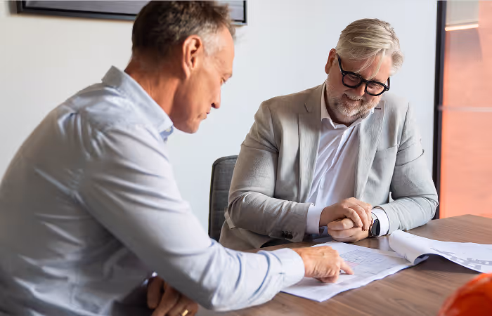 two business leaders looking over plans