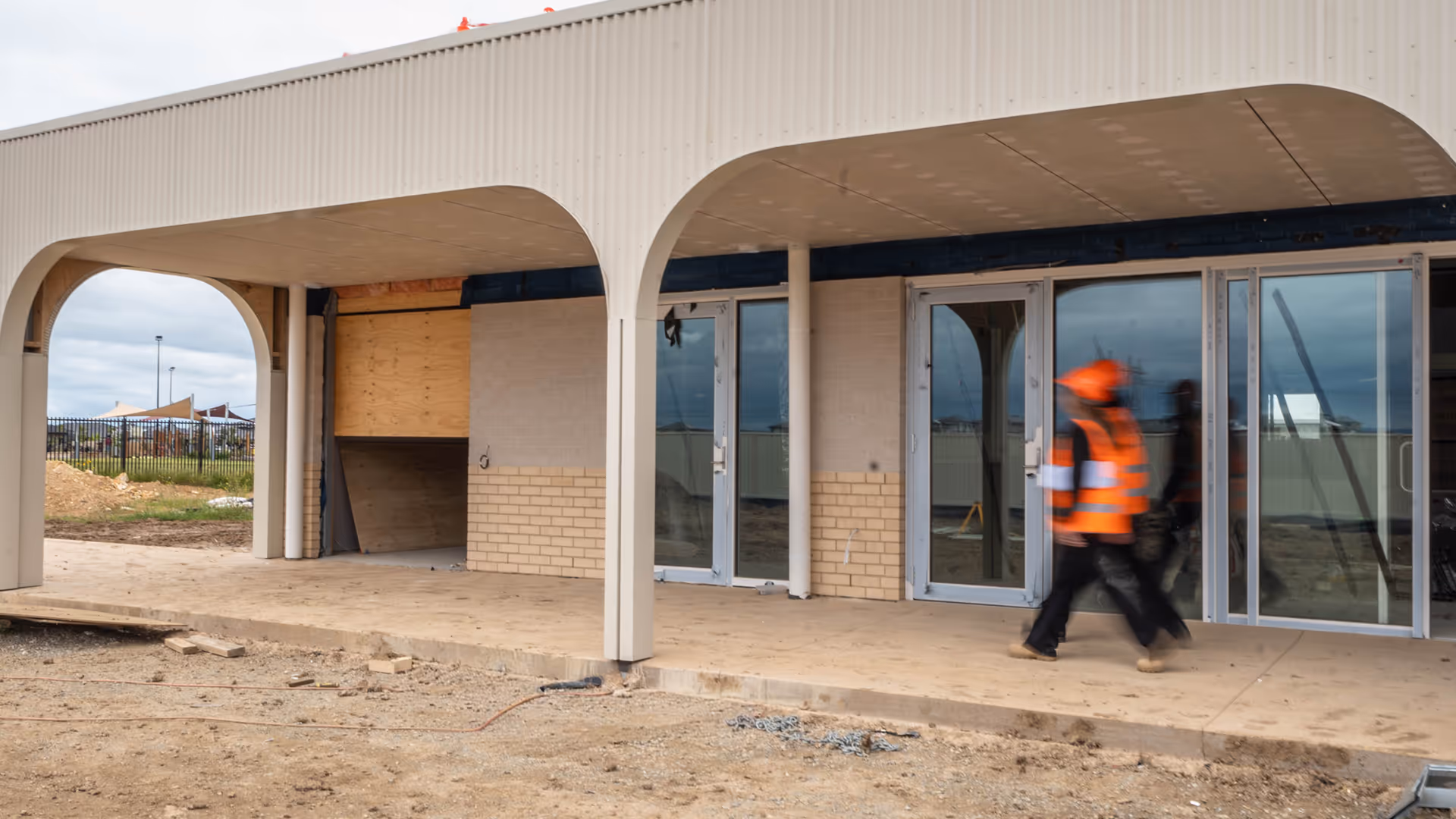 two people walking through a job site