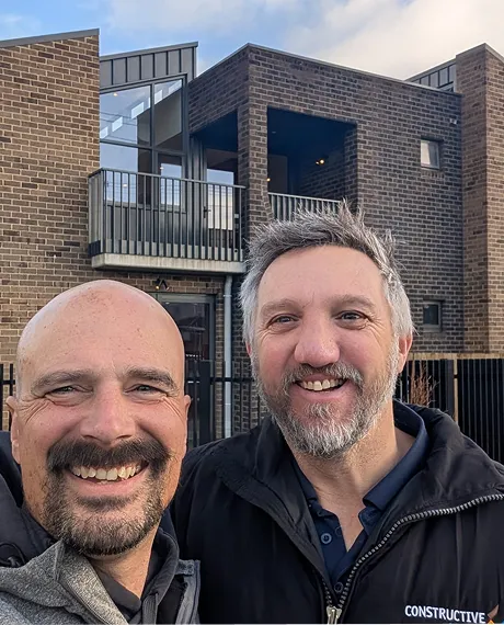 two workers taking a selfie with project