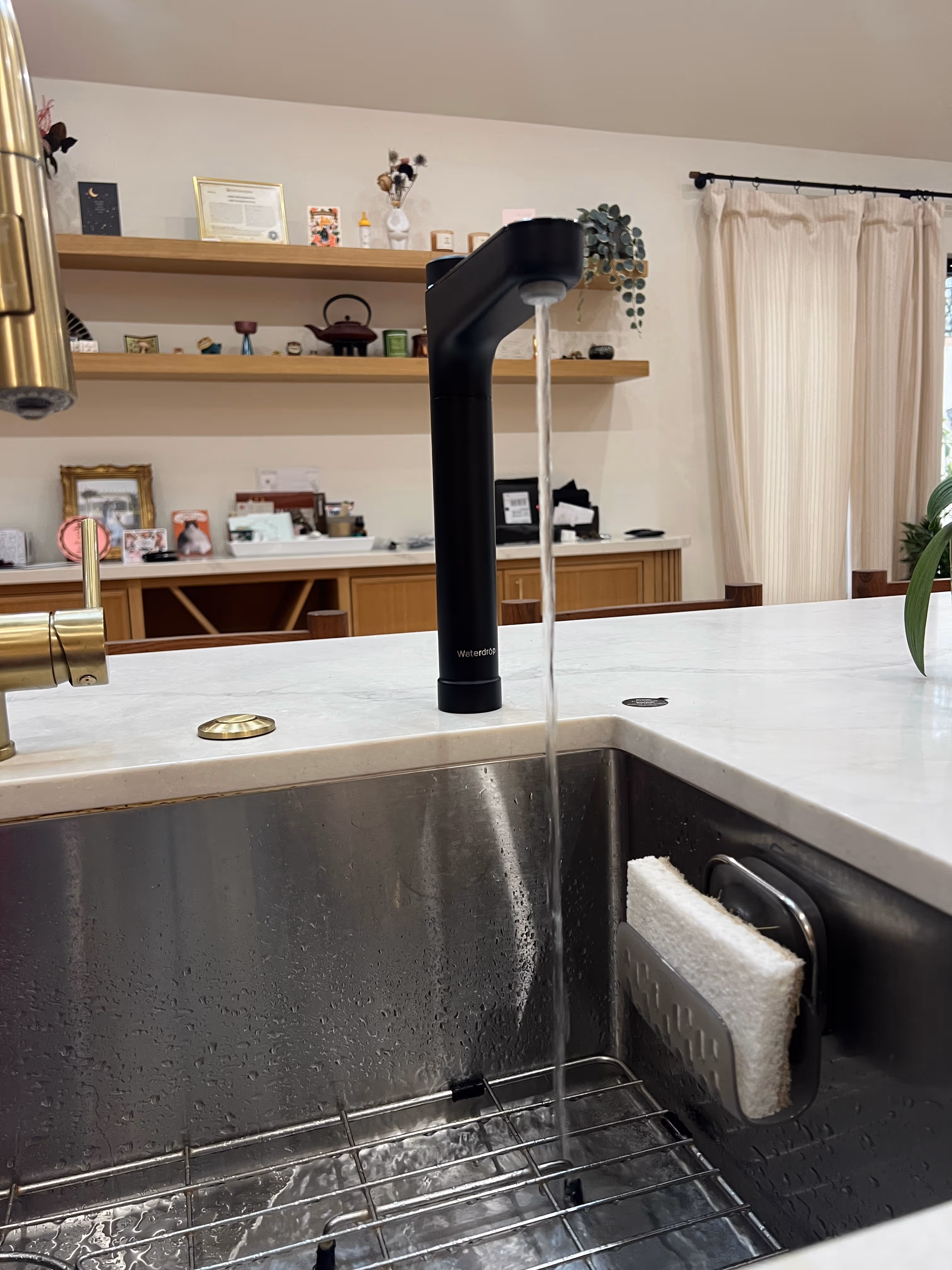 A picture of a black RO faucet installed on a white kitchen counter