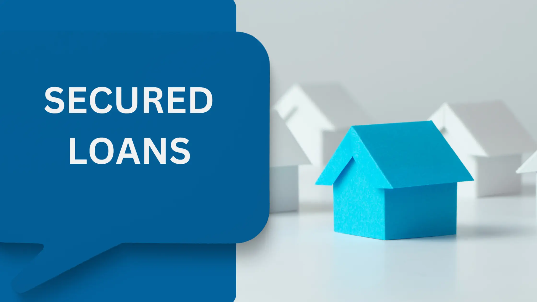 A small, light-blue paper house stands in the foreground, with several blurred white paper houses behind it. The text