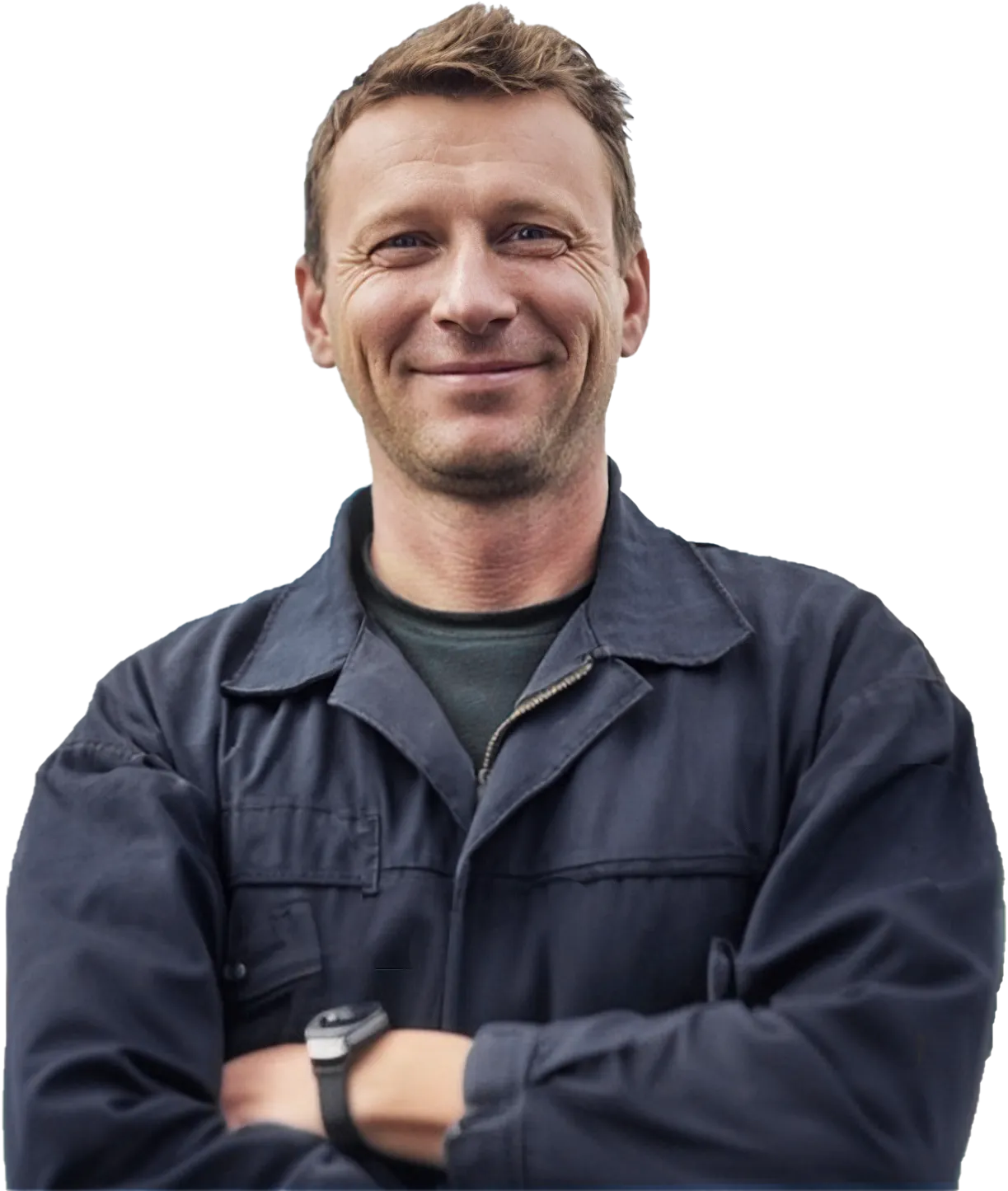 Lächelnder Prüfer mit kurzen braunen Haaren, schwarzer Arbeitsjacke und Uhr, der die Arme verschränkt.