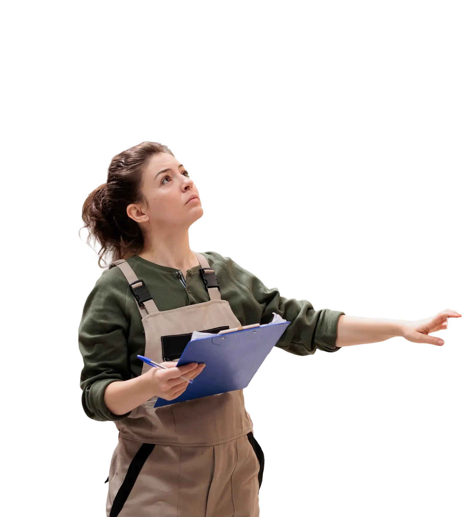 Woman in work overalls holding a clipboard and pen, looking and reaching upward with a focused expression.