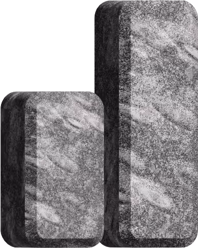 Two textured rectangular stone blocks, one smaller and one larger, standing upright side by side.