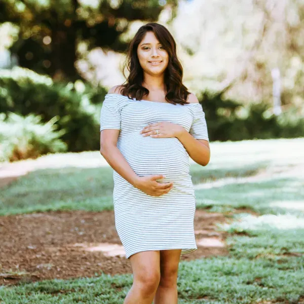 Donna incinta che sorride all'aperto | NIPT by GenePlanet