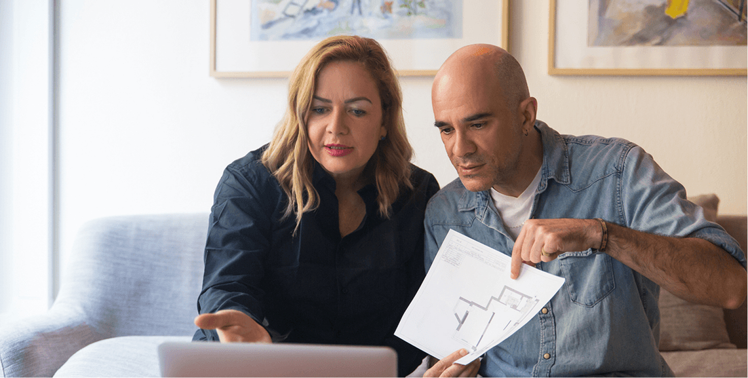 Couple reviewing documents at home