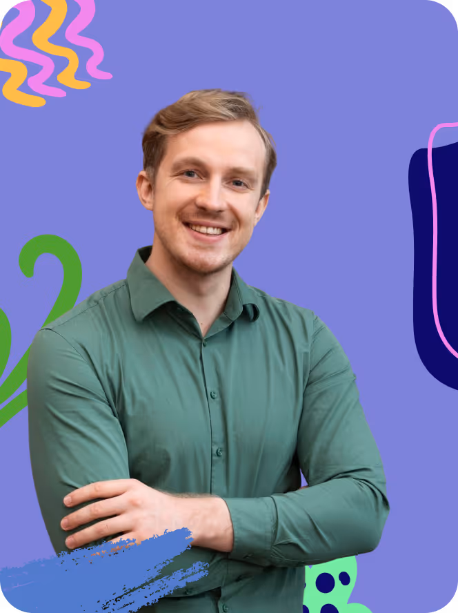 Smiling young man with light brown hair wearing a green button-up shirt, standing with arms crossed against a purple background with colorful abstract shapes.