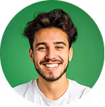 Smiling young man with dark hair and beard wearing a white shirt against a green background.