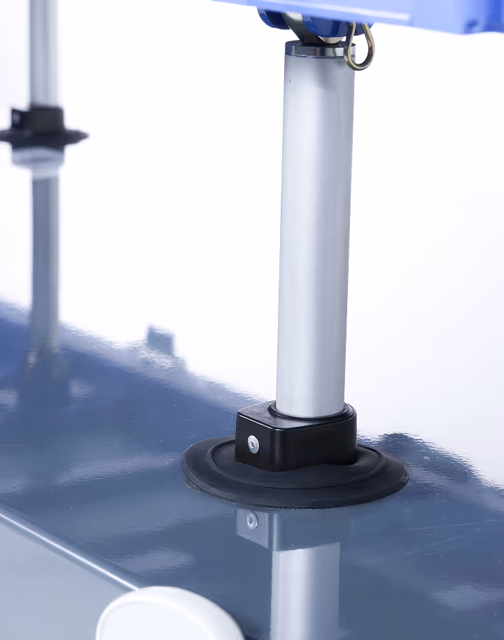 Close-up of a metal support leg with a black rubber base attached to a glossy blue surface.