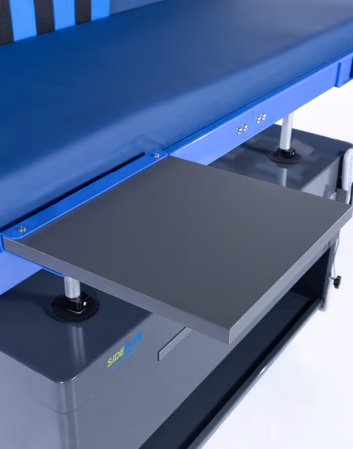 Close-up of a blue padded medical examination table featuring a gray side lever platform and metal support legs.