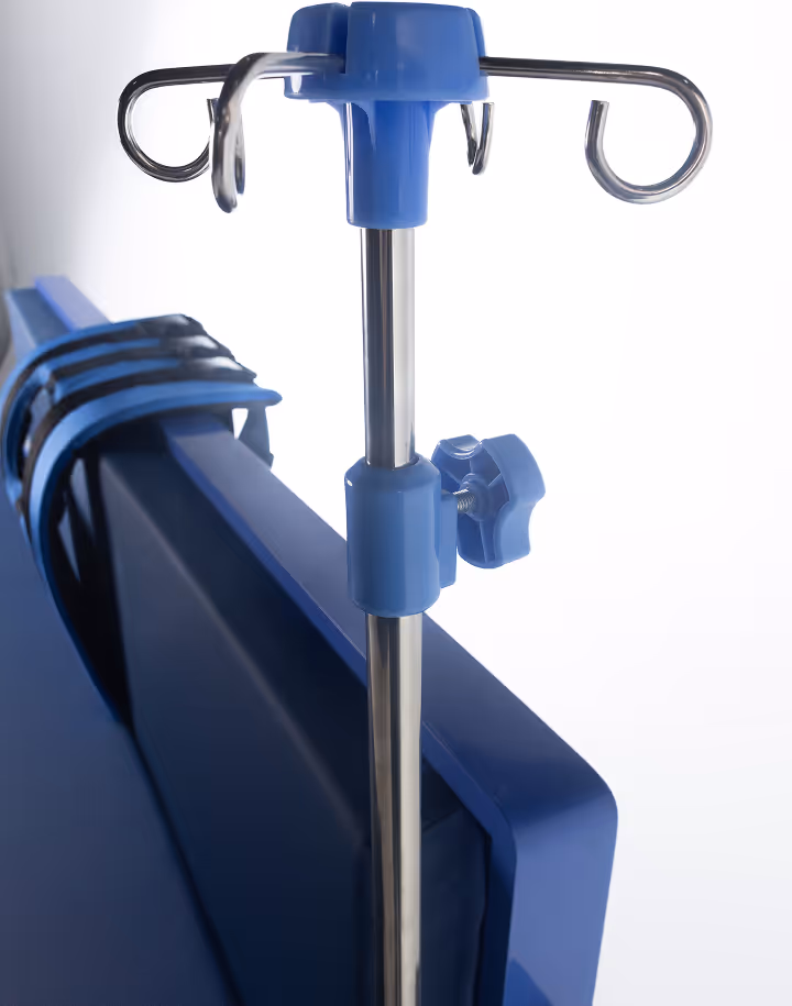 Close-up of a blue and stainless steel IV pole attached to the side of a blue hospital bed with adjustable straps.