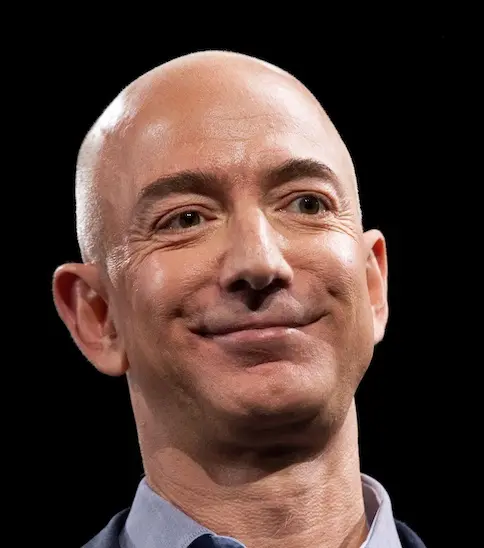 Close-up of a bald man with a slight smile against a black background.