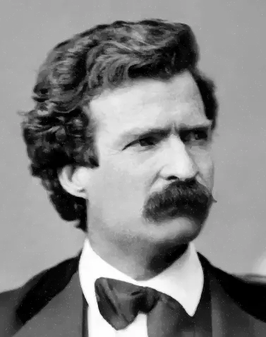 Black and white portrait of a man with curly hair and a thick mustache wearing a bow tie and formal suit.