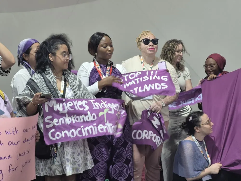 A group of women with disabilities holding posters
