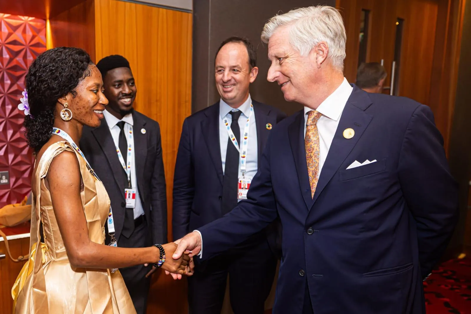 Esther Nagetey, a blind person and IDA Youth and Gender Ahviser holding hands with the King of Belgium.