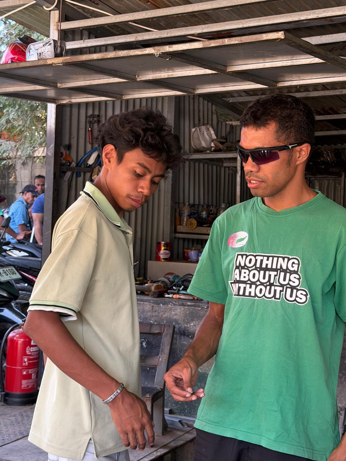 A young blind man in an OPD learning how to repair motorbikes