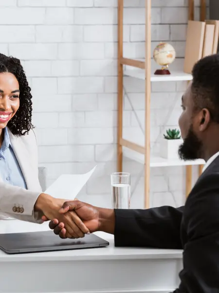 A recruiter and hiring manager shaking hands.