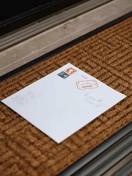 A letter on a door mat.