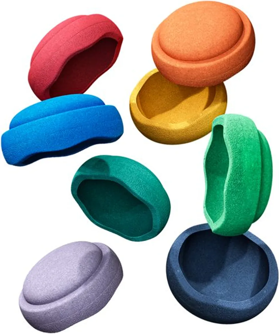 Colorful climbing holds in various shapes and colors including red, blue, orange, yellow, green, purple, and dark blue on a white background.