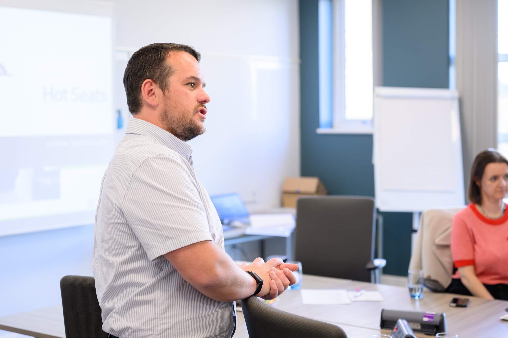 Photo shows Business mastermind founder Jamie Holland coaching