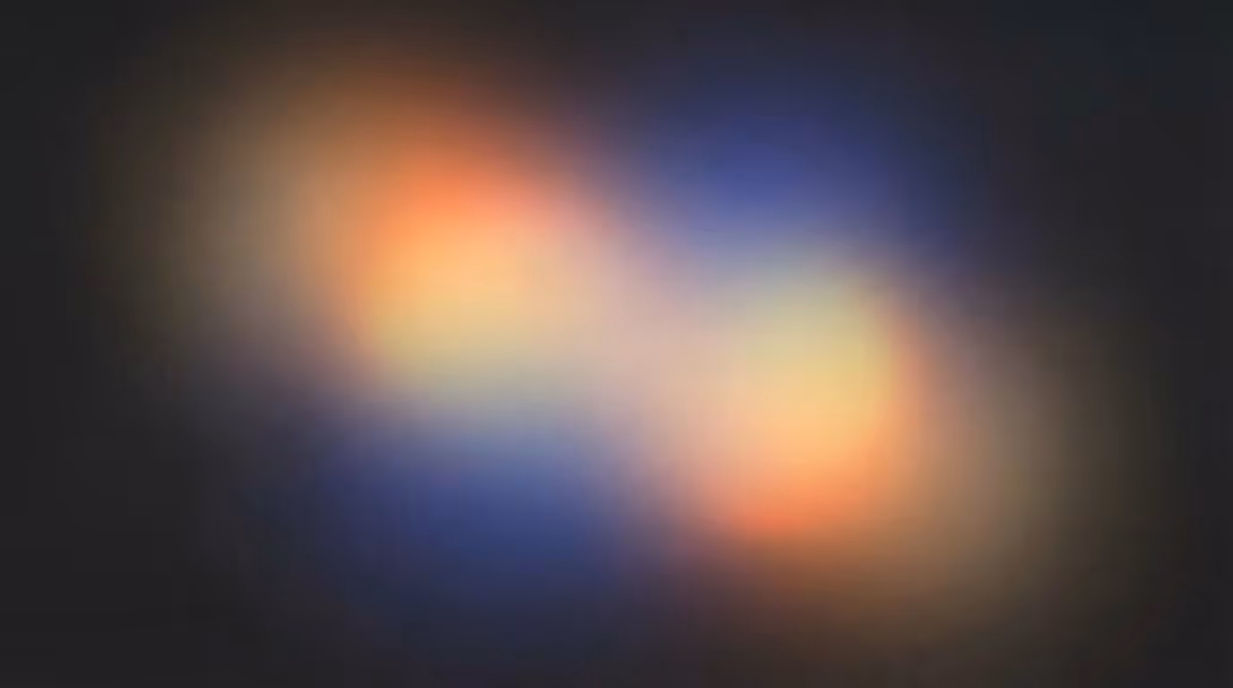 Soft, blurred light spots in warm orange, blue, and purple on a dark background.
