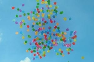 Different Colored Balloons Floating In The Sky