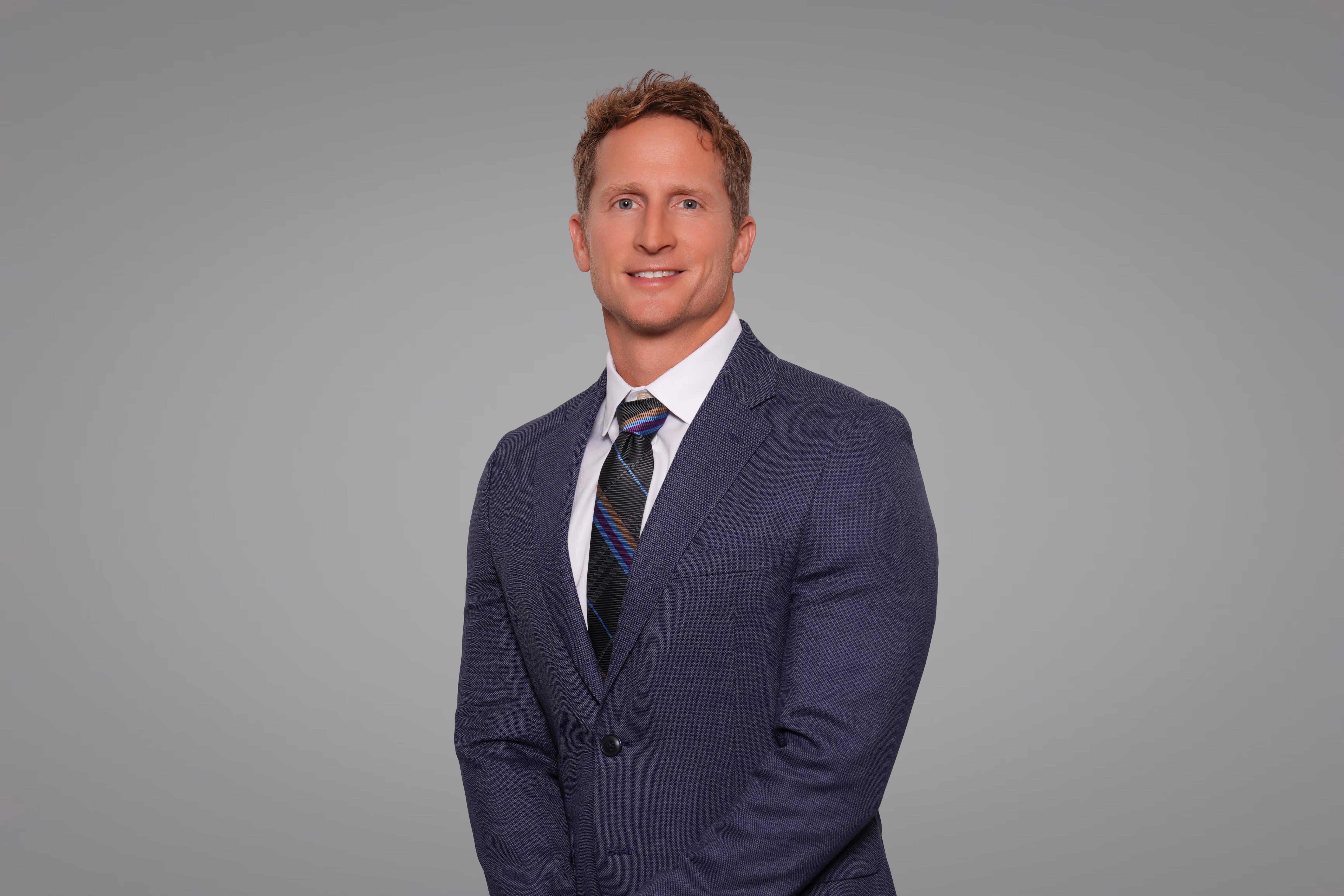 Dr. Rich Herring wearing a suit and tie.