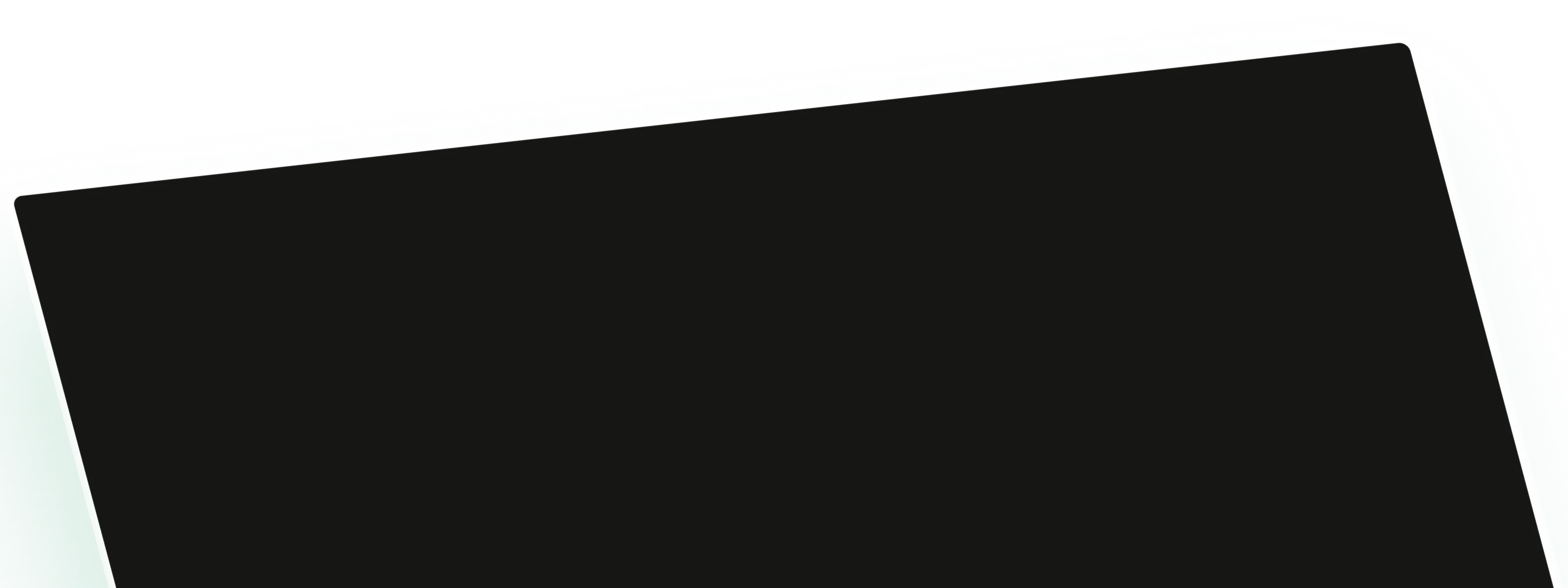 Close-up of a black tablet or smartphone screen with a silver frame on a green surface.