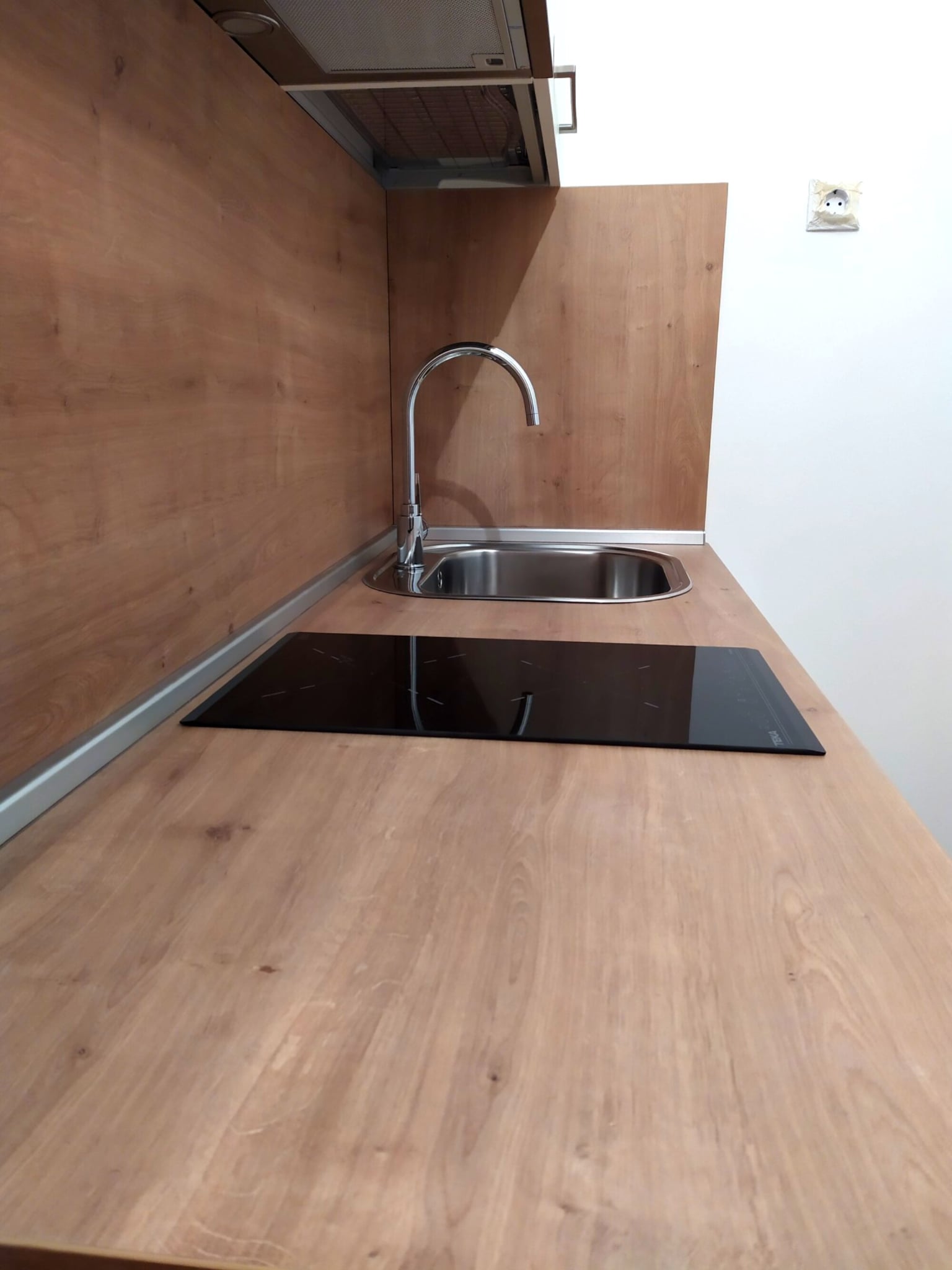 Детайл от плот H3303 ST10 с вграден котлон и иноксова мивка под аспиратор за вграждане