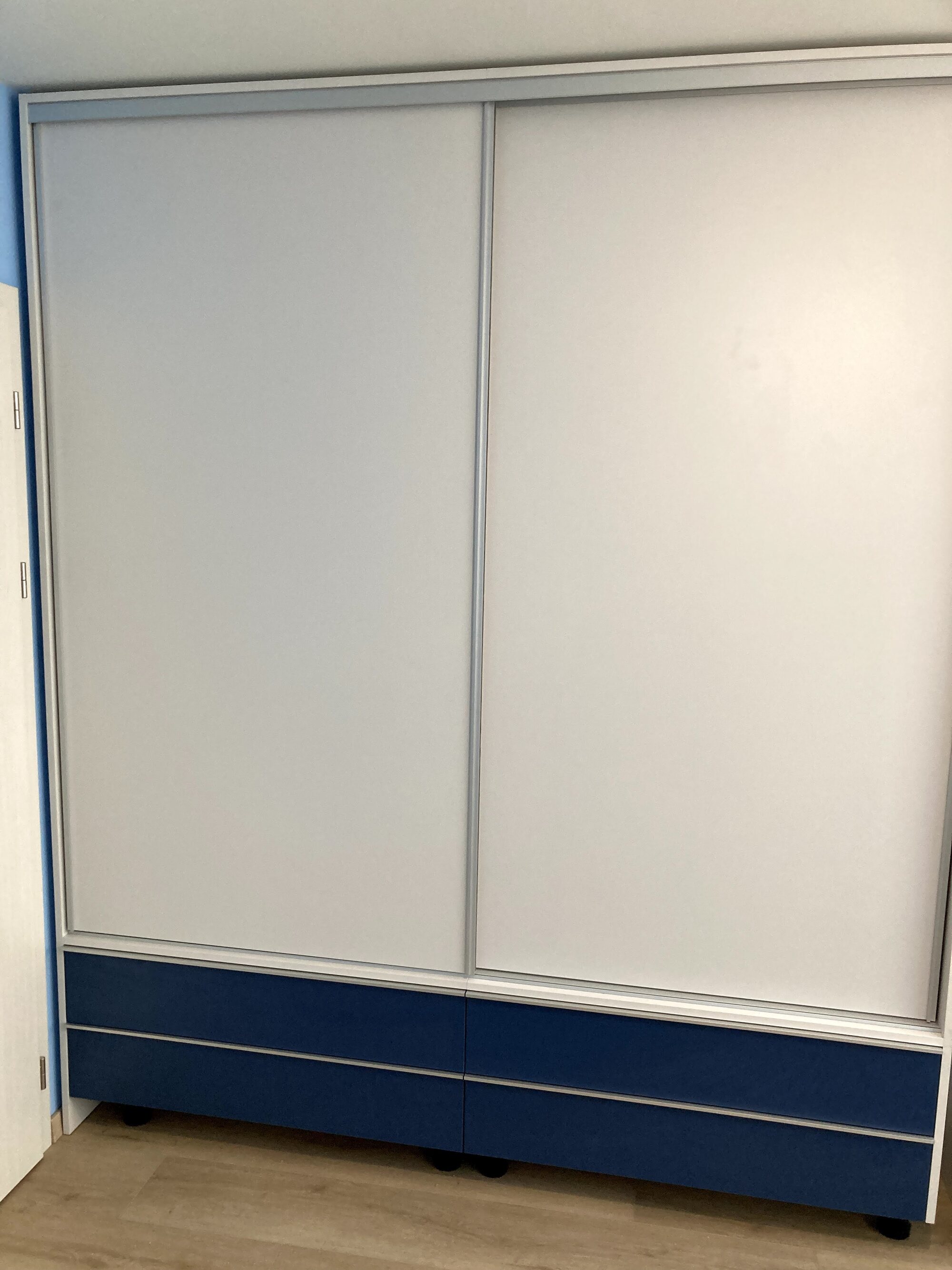 Гардероб с плъзгащи врати и долни чекмеджета в контрастен син цвят
