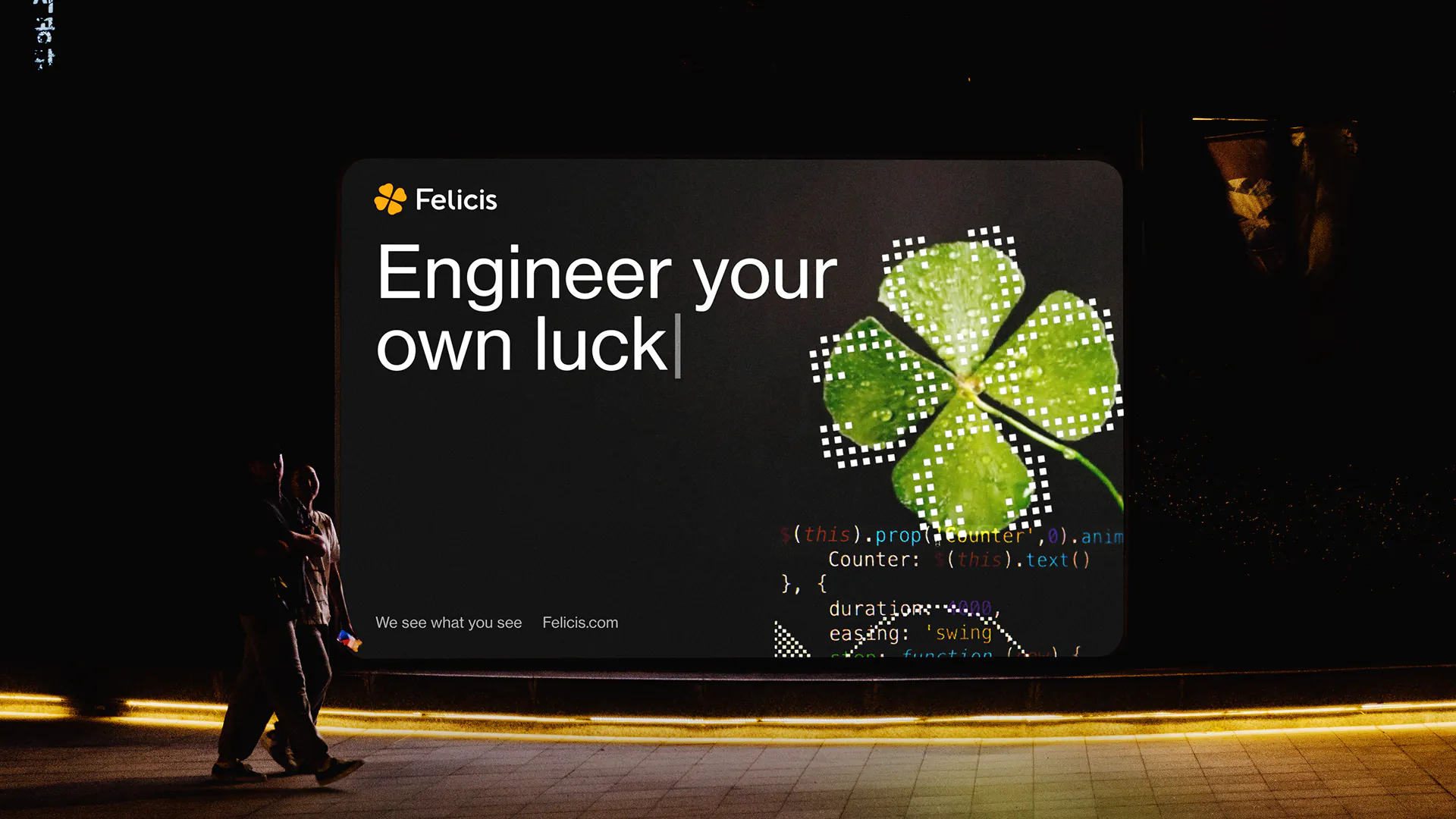 Digital billboard at night showing a four-leaf clover and the text 'Engineer your own luck' with programming code elements in the background.
