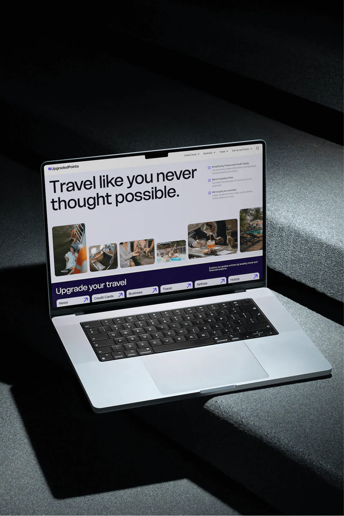 Open laptop displaying a travel website with the headline 'Travel like you never thought possible' and various travel-related images and navigation links.