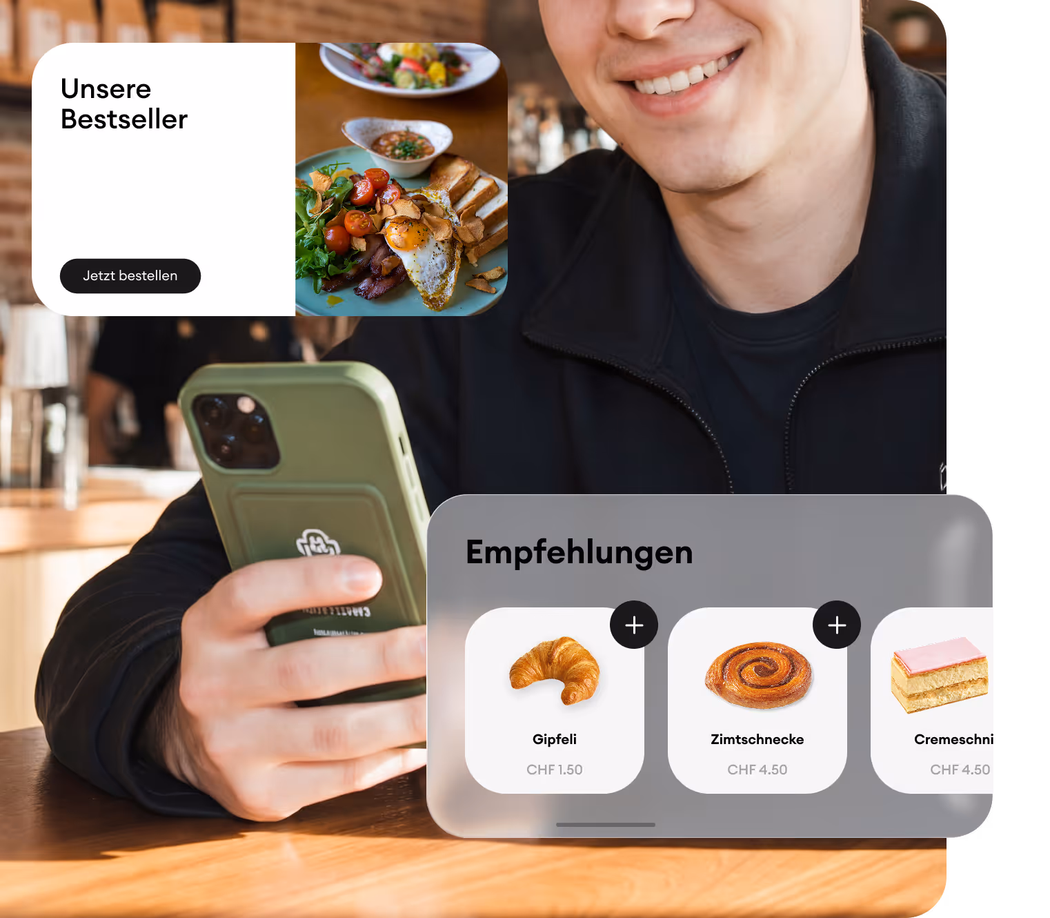 Junger Mann hält ein Smartphone mit einer mobilen Bestell-App, die beliebte Frühstücksartikel und Empfehlungen wie Gipfeli, Zimtschnecke und Cremeschnitte anzeigt.