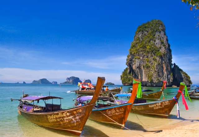 Long-tail boats on a beach in Krabi, Thailand, representing a country tap water safety guide.