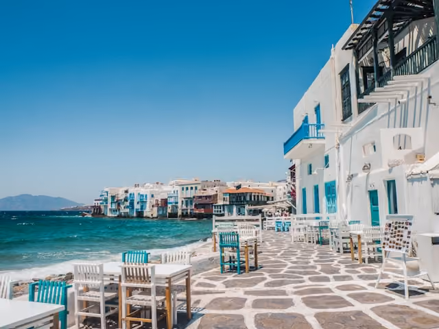 Whitewashed buildings overlooking the Aegean Sea in Mykonos, Greece