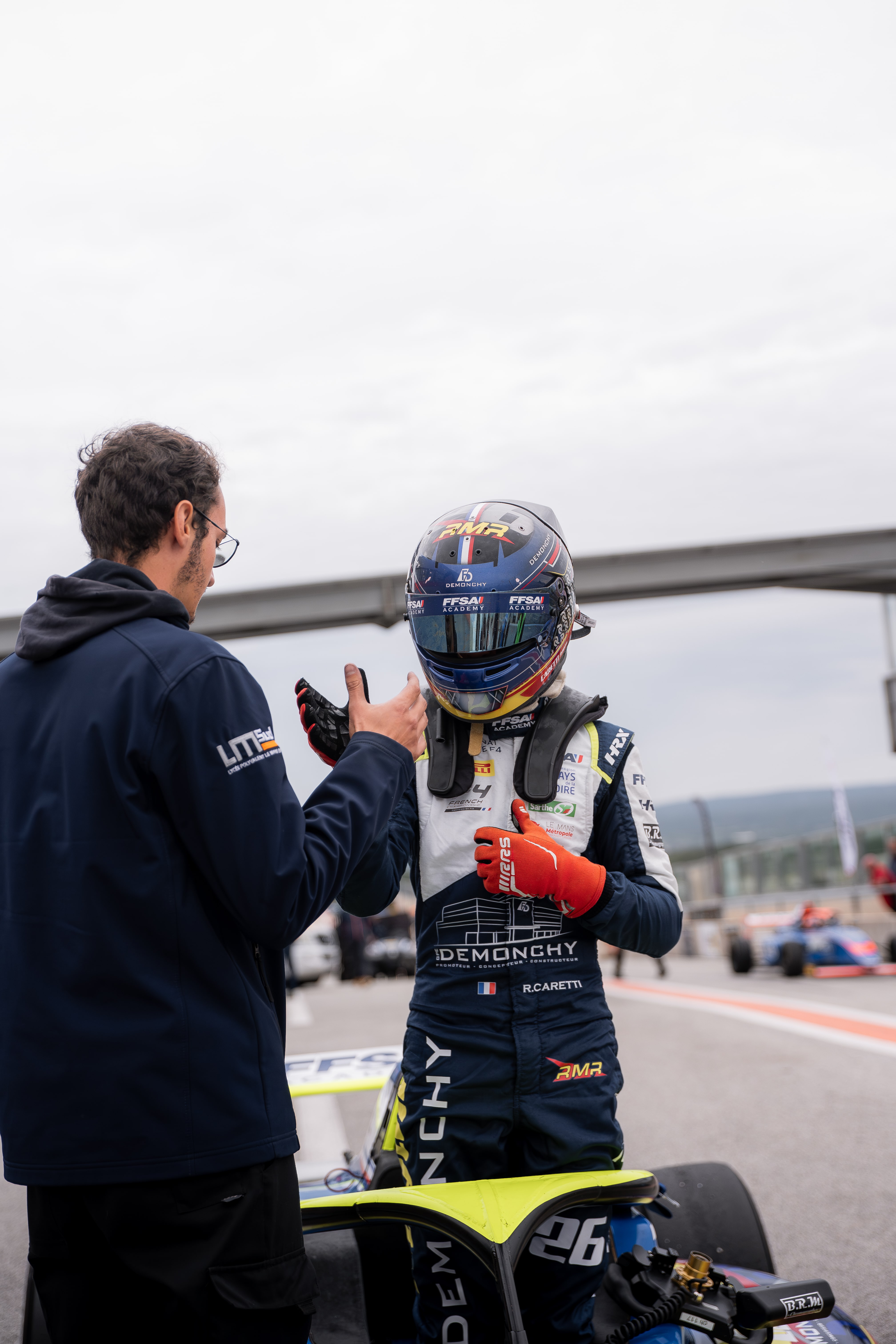 Rayan Caretti shaking hands with his F4 mechanic