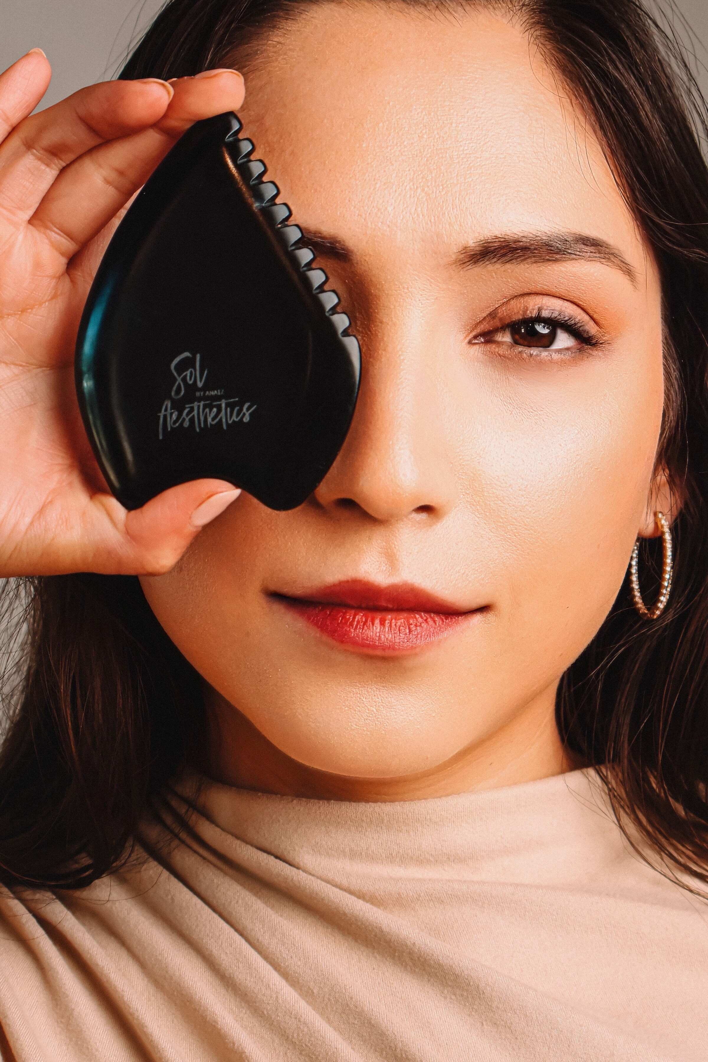 Anaiz Zambrano performing a holistic facial ritual with Gua Sha and lymphatic drainage at Sol Aesthetics in Chandler, Arizona