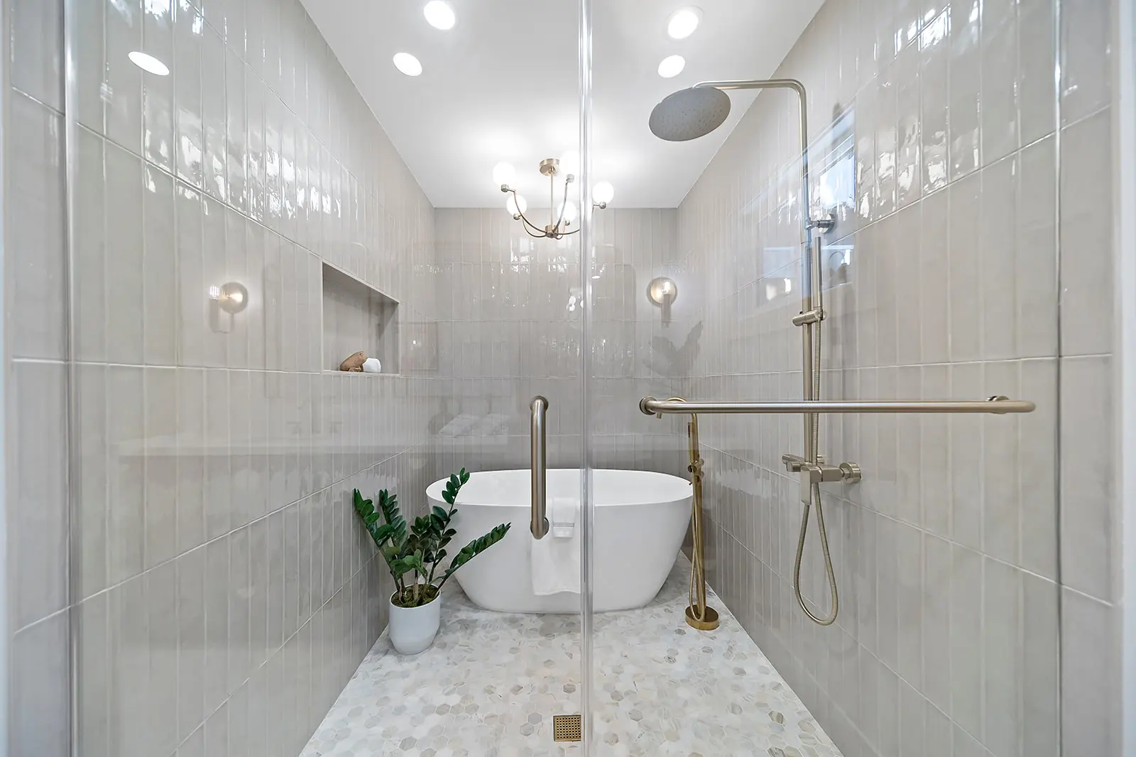 Premium powder room design by Enhaus Design & Build, highlighting a custom floating Calacatta Viola marble trough sink paired with dual wall-mounted unlacquered brass faucets.