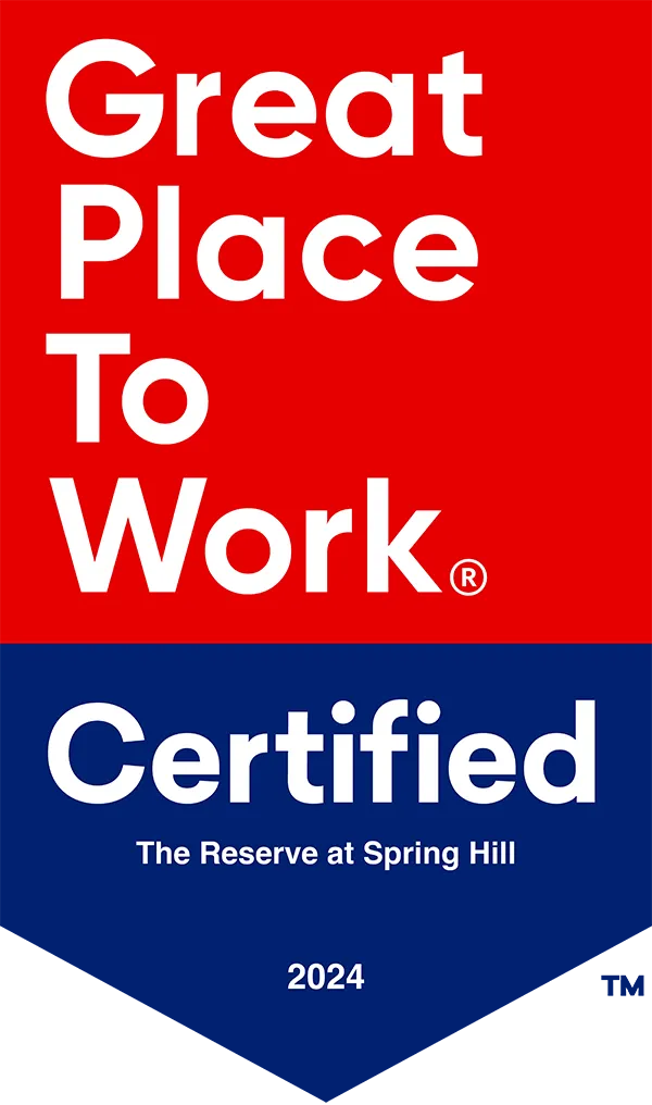 Sign displaying "Great Place to Work Certified, The Reserve at Spring Hill, 2024" in red and blue.