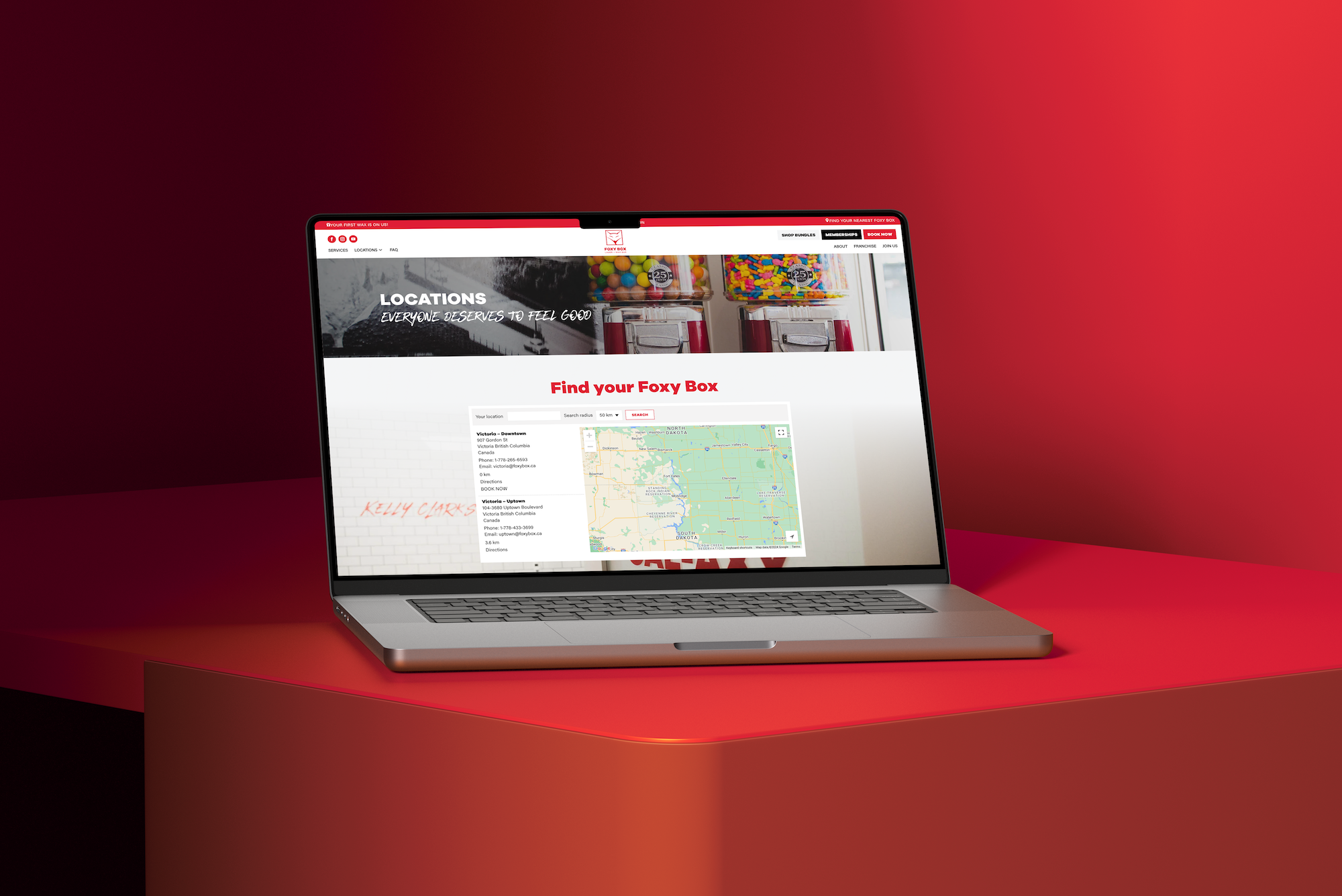 foxy box website on a laptop sitting on a red block with a bright red background