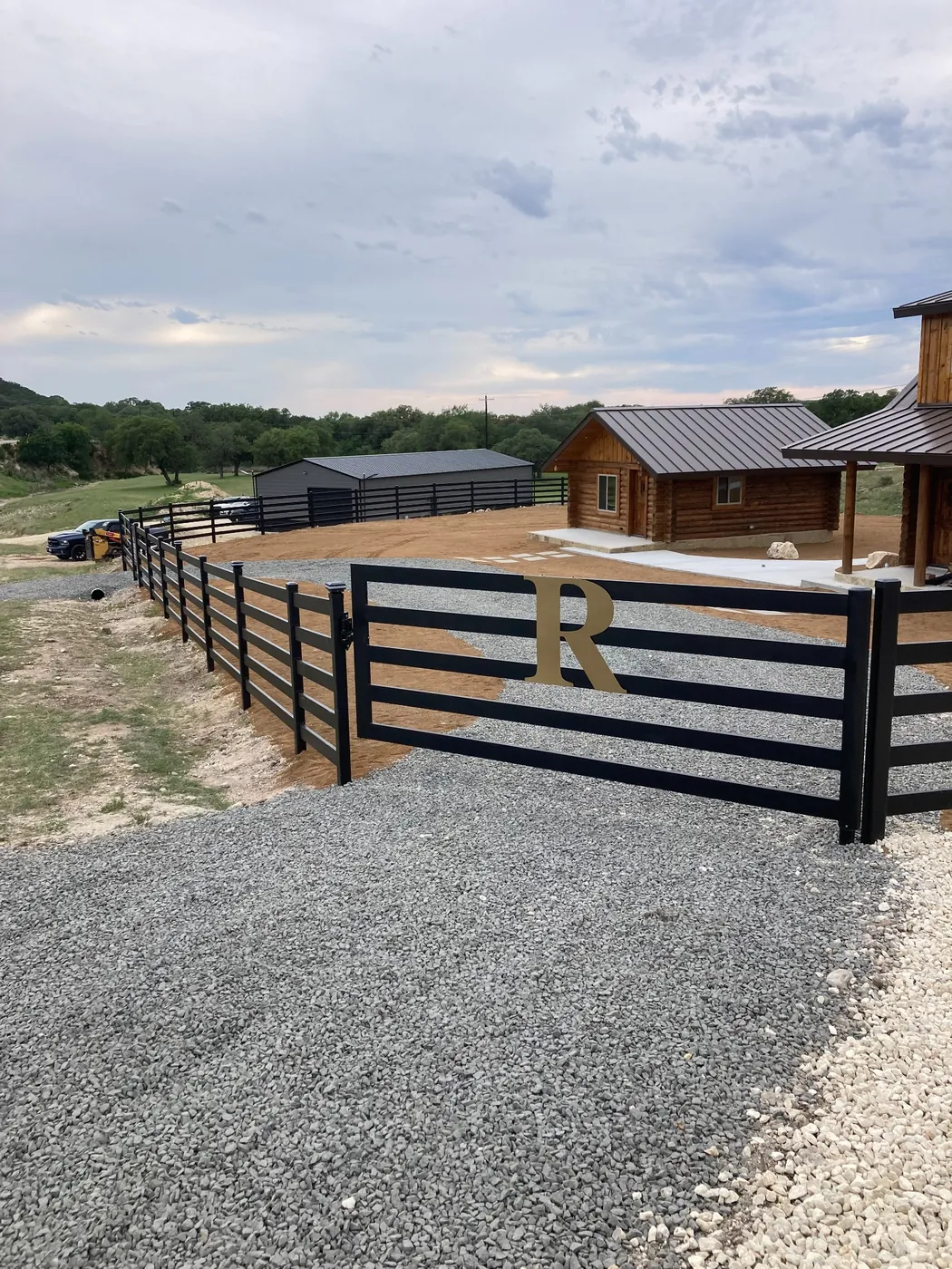 Five-rail black Buckley Steel Board fence and vehicle gate at Chad's Texas cabin property