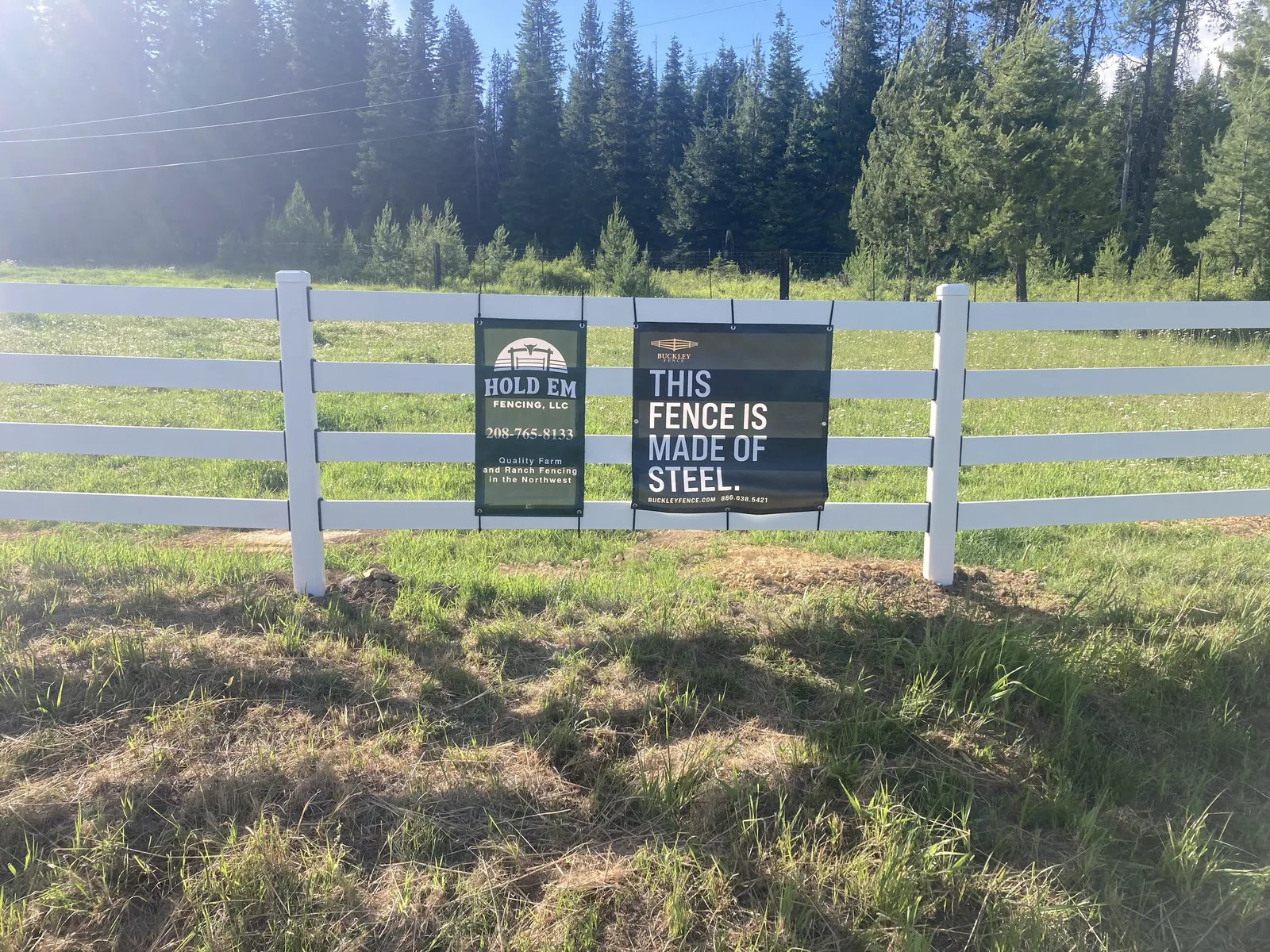 White Buckley Steel Board fence beside the roadside at the Clarkia, Idaho horse property