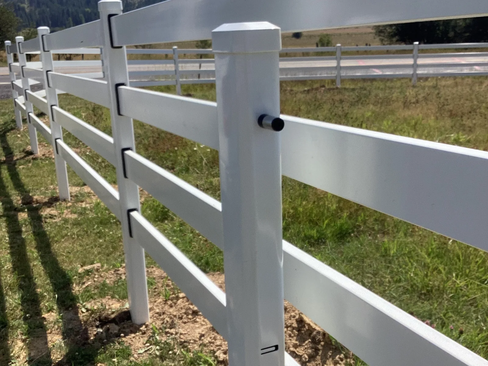 Perspective along a white Buckley Steel Board corner post at the Clarkia horse property