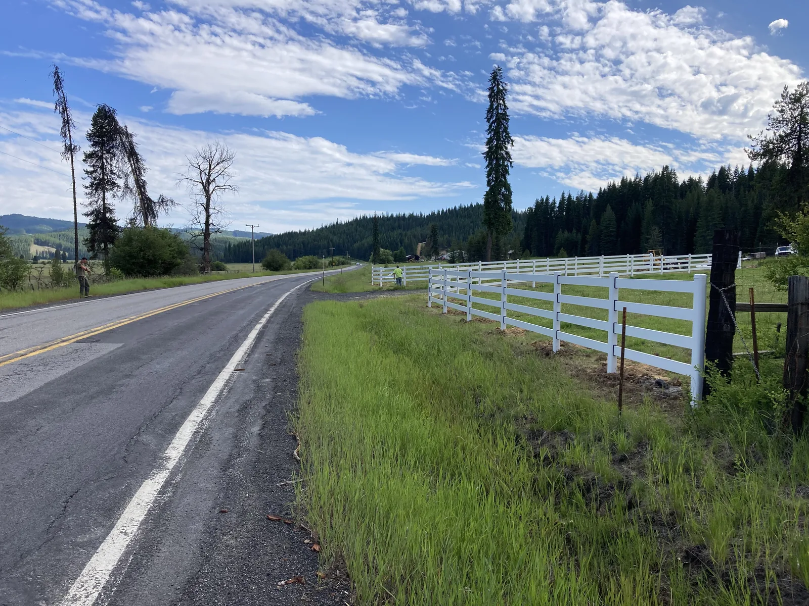 White Buckley Steel Board fence along the highway frontage at the Clarkia, Idaho horse property